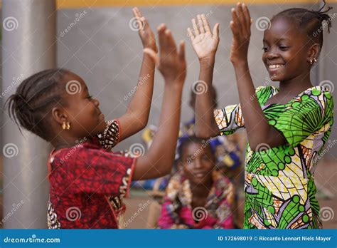 Two Little African Girls Performing A Hand Clapping Game Stock Image