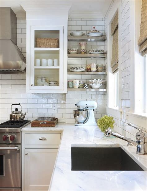 White subway tiles laid in a tight horizontal brick bond pattern pop against the dark grout. The classic beauty of subway tile backsplash in the kitchen