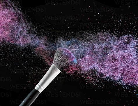 Coloured Make Up Powder And Beauty Brush In Front Of Black Background