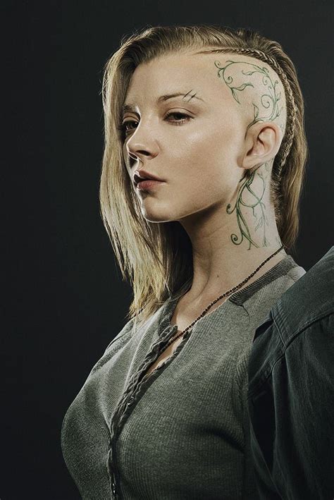A Woman With Tattoos On Her Head And Neck