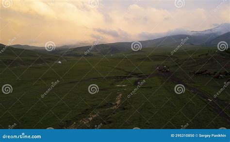 Pink Purple Sunset In Mountains With Green Fields Stock Photo Image