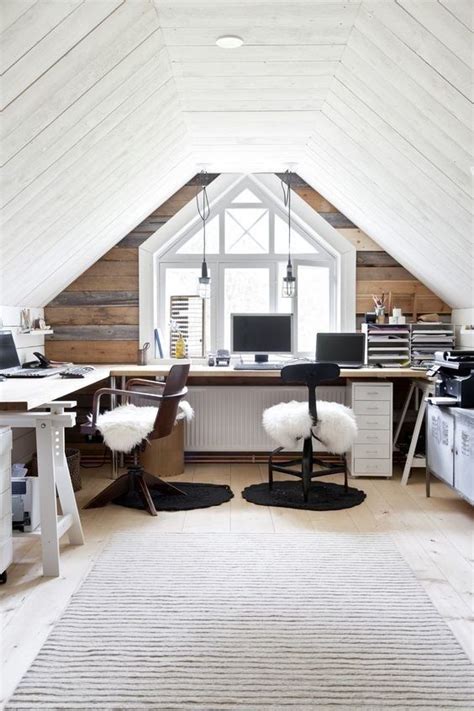 An Attic Office With Two Desks And Chairs In The Corner Along With A