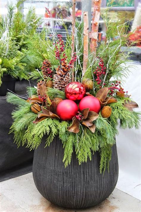 A Large Urn Evergreens Pinecones Berries Leaves And Oversized