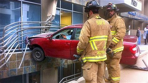 driver crashes into side of building car suspended 20 feet