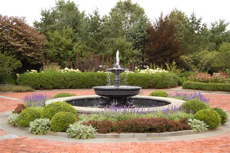 An Aluminum And Lead Fountain In Circular Driveway In Front Of House