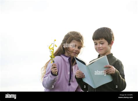 Children Reading Together Outdoors Stock Photo Alamy