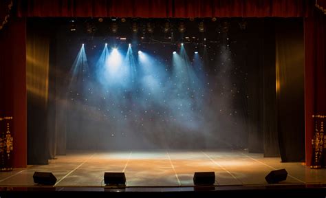 The Stage Of The Theater Illuminated By Spotlights And Smoke From The