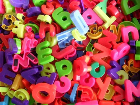 Colorful Plastic Letters And Numbers Are Scattered Together
