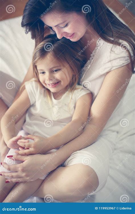 mother with her cute little daughter sitting on bed stock image image of home lifestyle