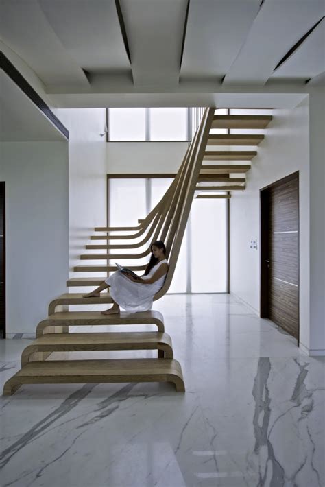 A Sculptural Staircase With Two Flights Of Stairs That Connect Seamlessly