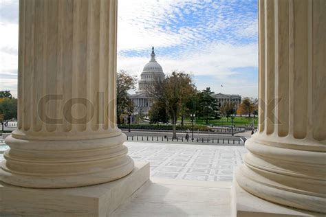 The United States Capitol Building Viewed From The Marble Columns Of