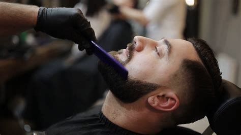 Barber Shaves Beard Of Client With Trimmer Stock Footage Sbv Storyblocks