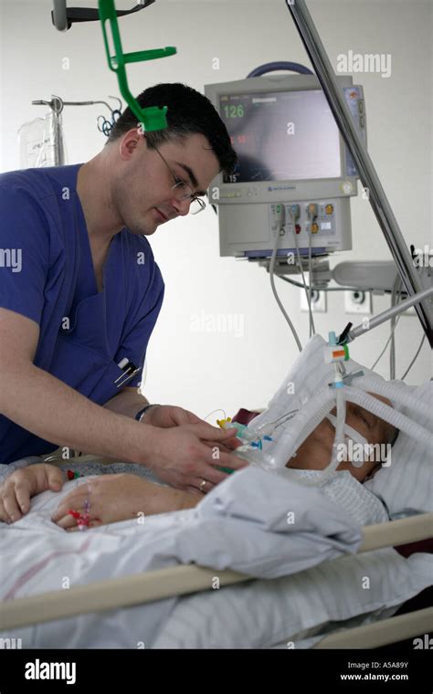 A Male Nurses And A Patient On The Intensive Care Unit Stock Photo Alamy