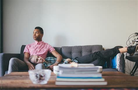 Portrait Of Young Interracial Gay Couple On A Couch By Stocksy