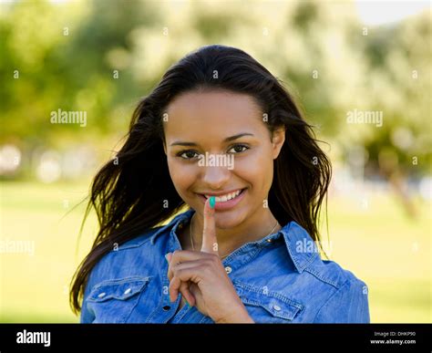 Outdoor Portrait Of A Beautiful African American Woman Asking Silence