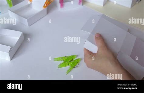 Woman Hands Glue Paper Box Template And Clamp Details With Clothespins