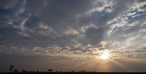 African sun bursts through cloudy sky - PatternPictures