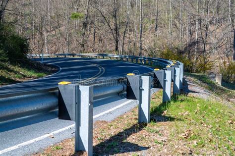 Closeup Of Guard Rail Going Around A Curve On A Country Road Stock