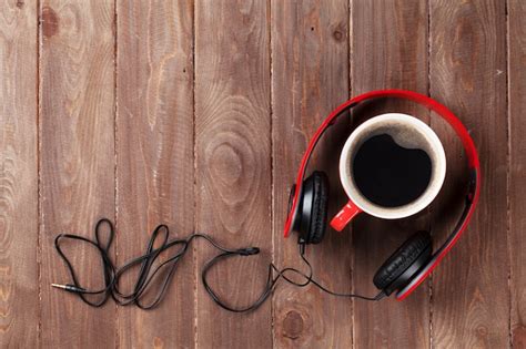 Premium Photo Headphones And Coffee Cup On Wooden Desk Table Music