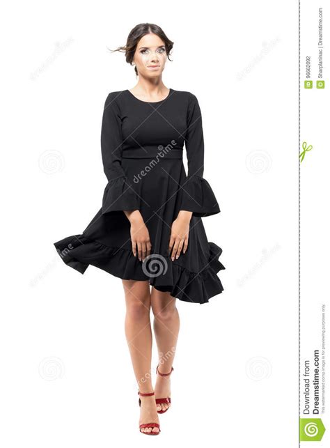 Woman Walking Front Holding Black Flying Dress With Blowing Wind In