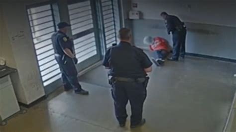 Corrections officer seen on video striking shackled, hooded inmate - CBS News