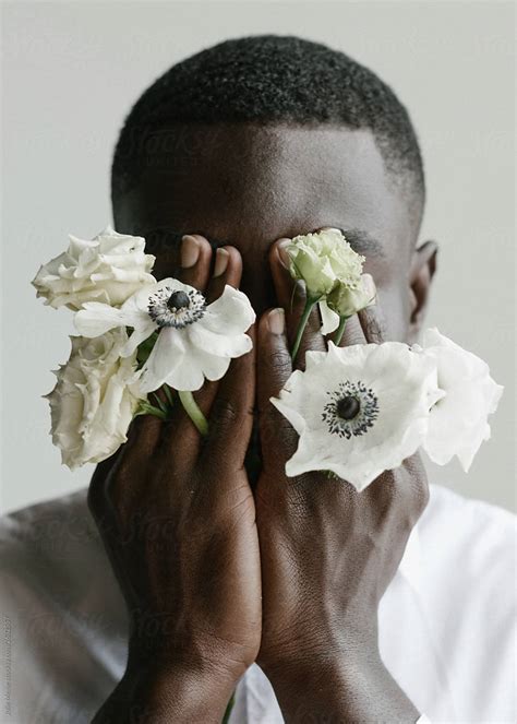 Portrait Of Handsome African Guy Whos Covering His Face With His Arms