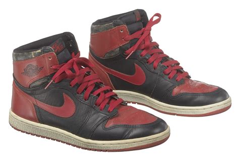 Pair Of Red And Black Air Jordan I High Top Sneakers Made By Nike