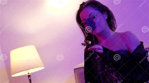 female dominatrix with crop is sitting in room and waiting lover portrait of bdsm mistress