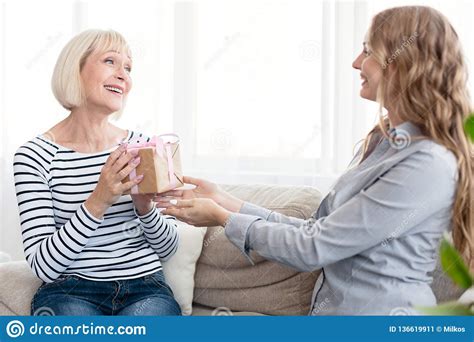 Happy Mother Receiving Birthday Present From Daughter Stock Image