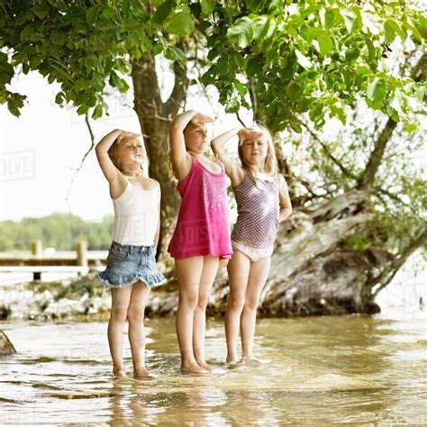 Smiling Girls Playing In Lake Stock Photo Dissolve