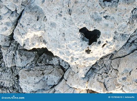 Heart Shaped Hole In A White Stone Textured Wall Stock Photo Image Of