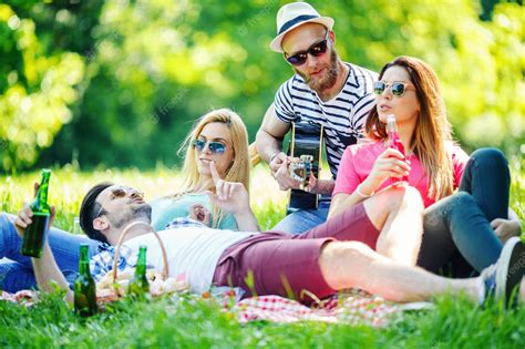 premium photo group of friends having picnic in the park