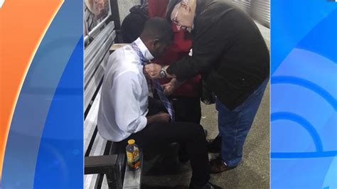 older man gives heartwarming necktie lesson in train station