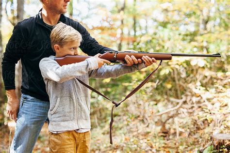 Father Teaching His Son How To Shoot A Rifle By Stocksy Contributor Kelly Knox Stocksy