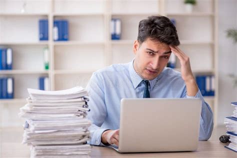 Young Male Employee And Too Much Work In The Office Stock Image Image