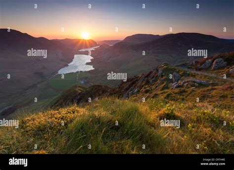 A View Of Buttermere At Sunset From The Summit Of Fleetwith Pike In