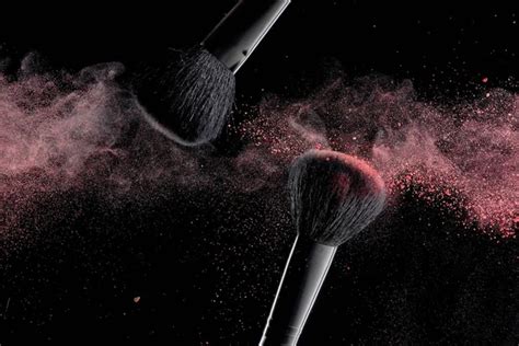 Makeup Brushes With Colorful Powder Explosion On Black Background High