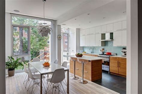 Inspiration for an expansive traditional kitchen in other with a farmhouse sink, shaker cabinets, white cabinets, marble benchtops, beige splashback photos in transitional kitchen in williamsburg. A Williamsburg Row House Gets a Modern Update