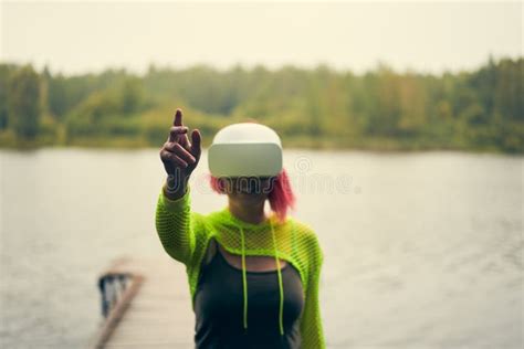 Woman Goes Into Virtual Reality Using Virtual Reality Headset Stock