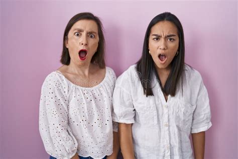 Hispanic Mother And Daughter Together In Shock Face Looking Skeptical