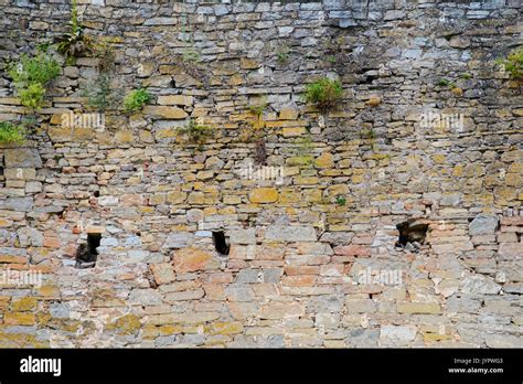 Texture Of Old Medieval Castle Wall With Loophole Made From Gray Stones