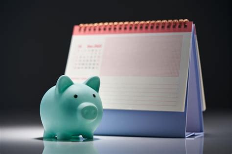 Premium Photo Piggy Bank And Desk Calendar