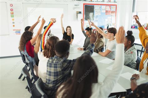 High School Students With Hands Raised In Debate Class Stock Image