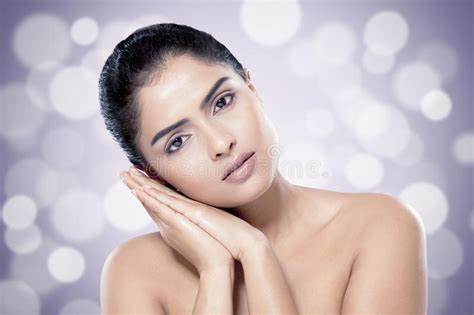 Beautiful Indian Woman With Healthy Skin Against Blurred Lights
