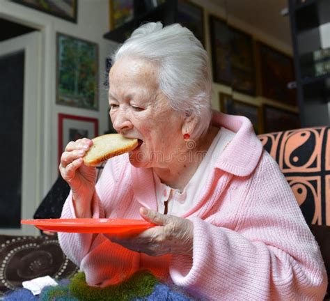 Old Woman Eating A Slice Of Bread Stock Image Image Of Woman Holding 47960879