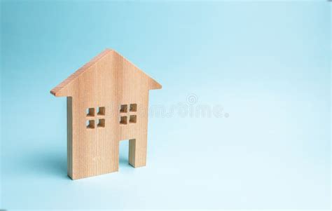 Wooden House On A Blue Background The Concept Of Affordable Housing