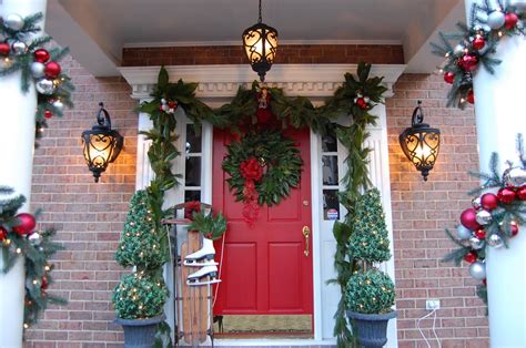 Vintage courtyard interior with stairs, porch, door and lights in windows. Decorating for Christmas with Magnolia and Pine