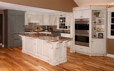 The distressed kitchen cabinets are a great choice for you who want to create the casually chic and welcoming design in your kitchen space. Distressed Kitchen with Island | Custom Cabinetry by Ken Leech