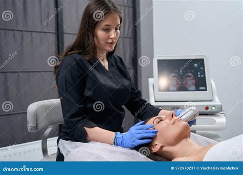 Beautician Doing Facial Skin Rejuvenation Procedure For Beautiful Lady