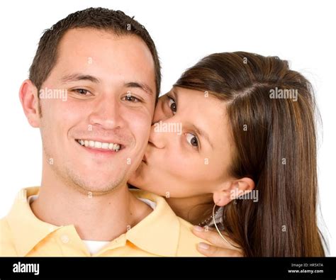 Couple Portrait Where The Girl Kissing Her Boyfriend Isolated Over A